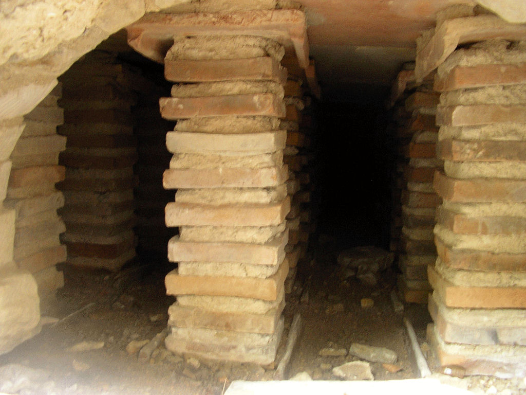 A hypocaust showing air channels and flues built into the floor and walls
